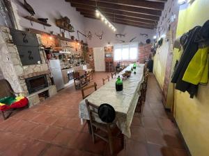 a large room with a long table and a kitchen at Casa Juan de castilseco 