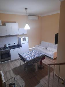 a small kitchen and living room with a table and a couch at Apt B.H rome (piazza bologna square ) in Rome