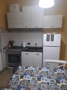 a kitchen with a table with a colorful quilt on it at Apt B.H rome (piazza bologna square ) in Rome