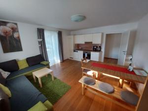 a living room with a couch and a table at Appartement Lengdorfer in Untertauern