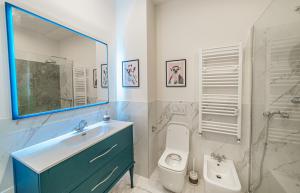 a bathroom with a sink and a toilet and a mirror at Romana Suites in Milan