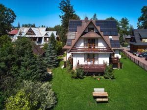 a house with solar panels on the roof at Goga in Zakopane