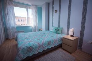 a bedroom with a bed and a window at Jasmin 2 in Stara Zagora