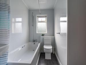 a white bathroom with a tub and a toilet at Chestnut House- 2 Bedroom house in Ashington, Northumberland in Ashington +19 photos