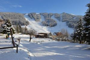 a snow covered hill with a ski resort in the distance at VILLARD DE LANS in Villard-de-Lans