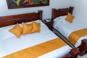 Postel nebo postele na pokoji v ubytování Hotel Aires del Quindío Armenia
