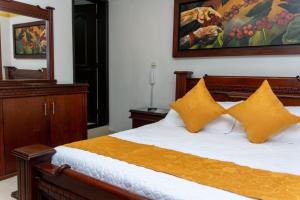 Postel nebo postele na pokoji v ubytování Hotel Aires del Quindío Armenia