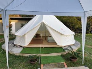 a large white tent in a yard with plants at StayKtion in Chiang Rai