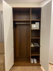 a closet with a door with a microwave in it at Royal Inn Residence New Cairo in Cairo +56 photos