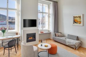 a living room with a couch and a fireplace at Hotel BOOKQUET in Prague
