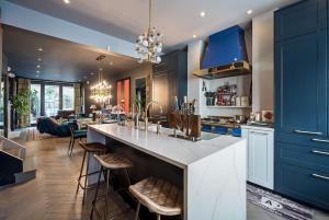 a kitchen with blue cabinets and a large island at Unique Chic Two Bed House Richmond in Richmond upon Thames