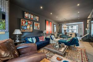 a living room with a couch and a table at Unique Chic Two Bed House Richmond in Richmond upon Thames