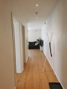 a hallway of a living room with a couch at Luxembourg Business Flat. Terrace & Free Parking in Luxembourg