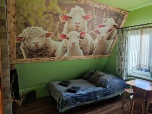 a room with a painting of sheep on the wall at Pokoje i Apartamenty Regionalny Styl ul Króle 1a Zakopane in Zakopane