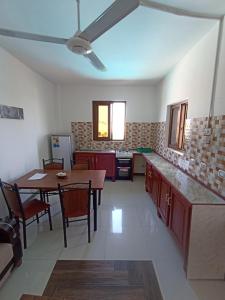 a kitchen with a table and a dining room at Jua Apartments in Kiwengwa