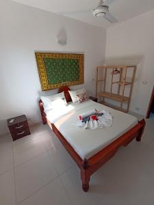 a bedroom with a large bed with white sheets at Jua Apartments in Kiwengwa