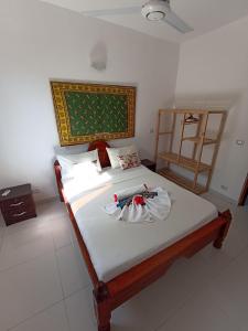 a bedroom with a large bed with white sheets at Jua Apartments in Kiwengwa
