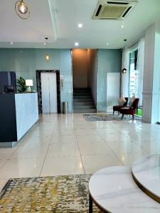 an empty lobby with a reception desk and chairs at Lovita Hotel Kuantan in Kuantan