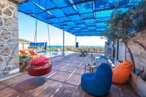 a wooden deck with swings and chairs on a house at Casa Dia in Patara