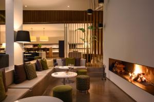 a living room with a couch and a fireplace at Inspira Liberdade Boutique Hotel in Lisbon