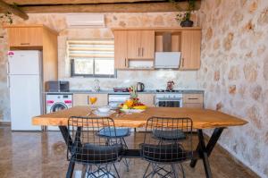 a kitchen with a wooden table with chairs around it at Casa Dia in Patara