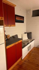 a kitchen with red cabinets and a counter top at Cozy little house in Tromsø city in Tromsø