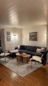 a living room with a couch and a table at Cozy little house in Tromsø city in Tromsø
