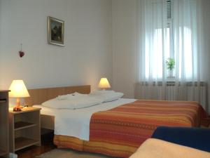 a hotel room with a bed and a window at Apartment Horvat in Zagreb