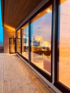 a room with large windows with a view of the ocean at Ekkerøy Lodge - Arctic luxury in Vadsø