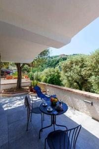 a table with a bowl of fruit on a patio at Villa Fratta Rooms peace of mind in Sorrento