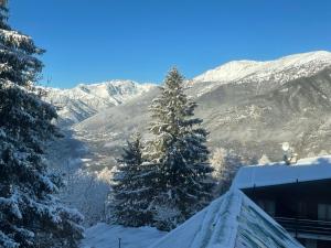 a view of a snow covered mountain from a house at Apartment Gran Baita Sauze d'Oulx in Sauze dʼOulx