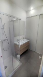 a bathroom with a glass shower and a sink at T2 neuf tout équipé, climatisé in Marseille