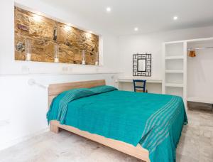 a bedroom with a bed with a green blanket at Cyprus Villages Hotel & Restaurant - Central Location - Bed & Breakfast - With Access To Pool And Stunning Views in Tochni