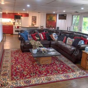 a living room with a leather couch and a rug at 2 Bedroom Apartment overlooks WCU and Cullowhee NC - Smoke and Pet free in Sylva
