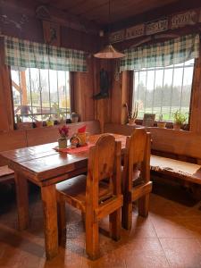 a wooden table and chairs in a living room at BUBLA CITY RANCH in Kopřivnice