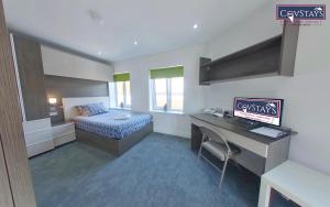 a room with a bed and a desk with a computer at New House - Magnificent Studios in Coventry City Centre, free parking, by COVSTAYS in Coventry