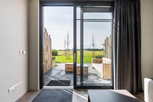 a room with a large glass door leading to a patio at Holiday Apartment Zee in Noordwijk