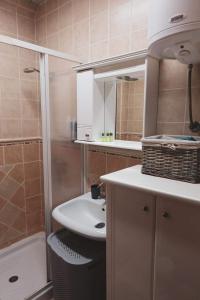 a bathroom with a sink and a toilet and a shower at Zlatibor Apartman Kraljev trg in Zlatibor