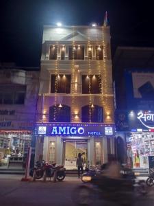 a building with anrica on the side of it at night at Hotel Amigo in Ratlām