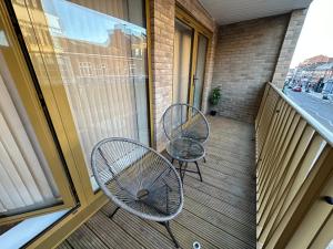 two chairs and a table on a balcony at LUXURY 2 Bedrooms - 2 BATHROOMS - F5 in London