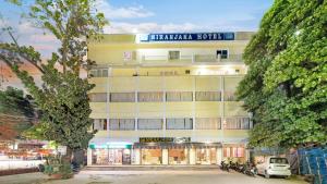 a white building with a sign on top of it at Niranjana Hotel Bodhgaya in Bodh Gaya