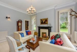 a living room with white furniture and a fireplace at Beech Bank - Georgian luxury near Hadrian’s Wall in Carlisle