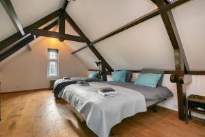 a bedroom with a bed in a attic at Edam Suites in Edam