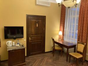 TV a/nebo společenská místnost v ubytování Guest House Pirklių Namai