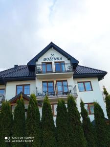 a building with a sign on top of it at Bożenka in Niechorze