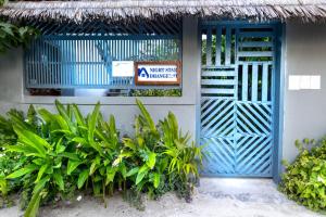 a blue door of a building with a sign on it at Night Star Dhangethi in Dhangethi +18 photos