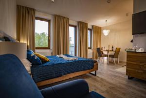 a bedroom with a bed and a dining room at APARTHOTEL Wałcz in Wałcz