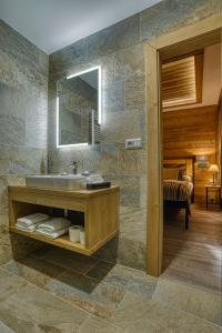 a bathroom with a sink and a mirror at Apartmán Jelení Grúň Jasná in Belá +25 photos
