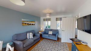 a living room with two couches and a flat screen tv at Anchor Down at The Bay, sleeps 4-6 in 2 bedrooms, dogs welcome too in Filey