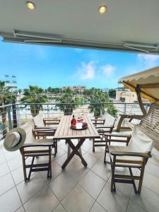 a patio with a table and chairs on a balcony at Mare Marina View 1 in Xylokastron